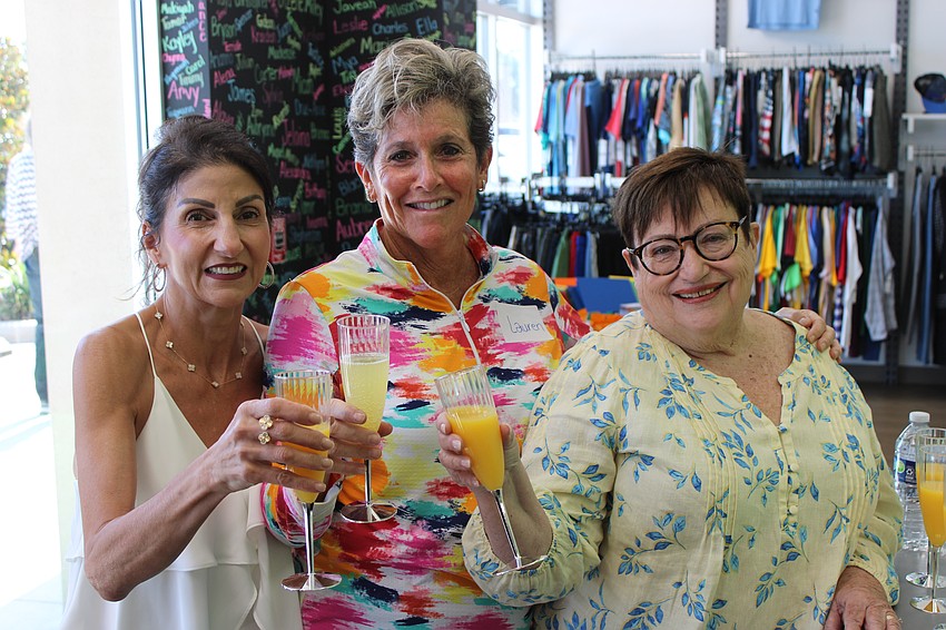Lake Club Women's Giving Circle members Barbara Najmy, Lauren Hirsch and Julie Swan celebrate the donation of 550 pairs of new sneakers to The Twig.